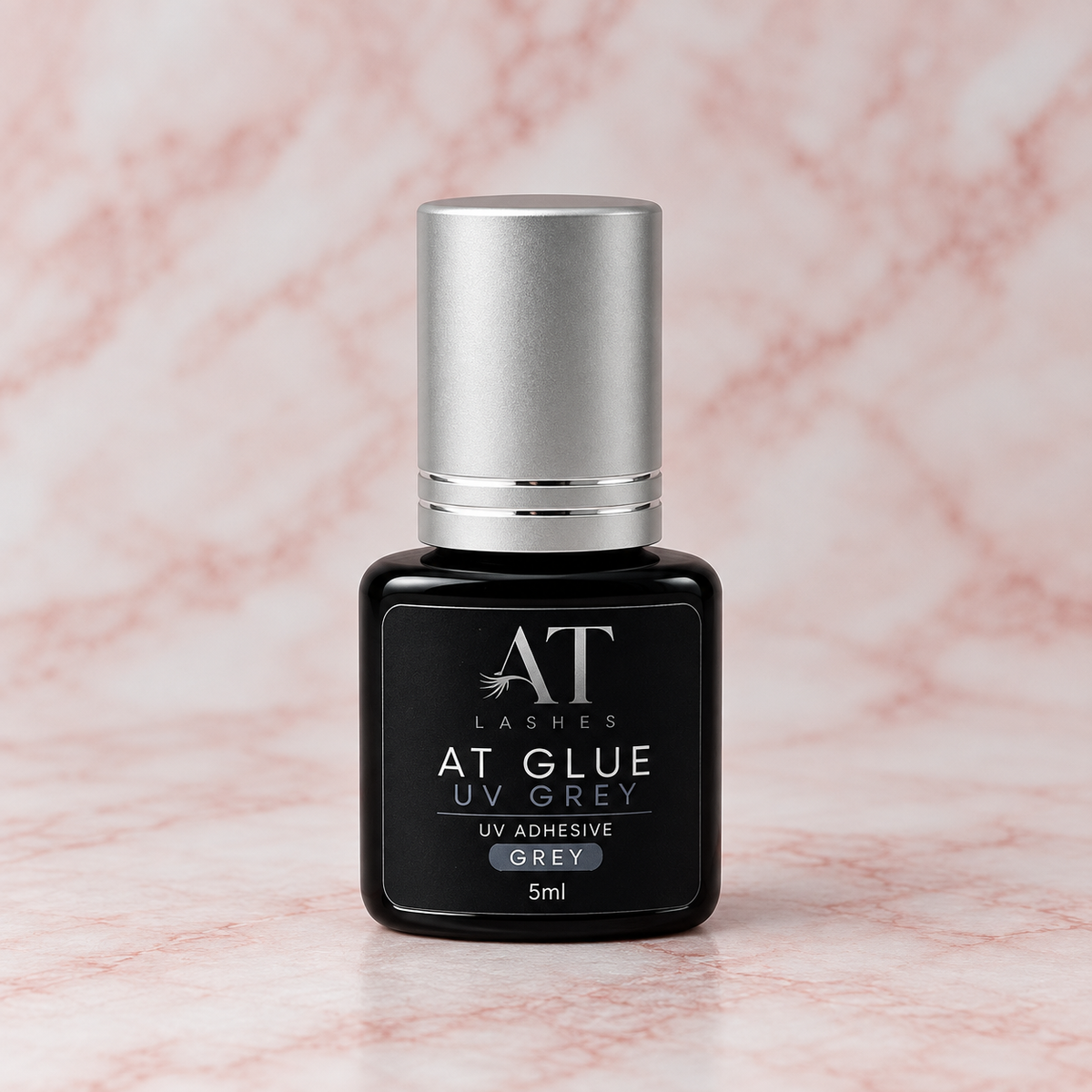 Flacone nero AT Glue UV Grey da 5 ml con tappo argento.